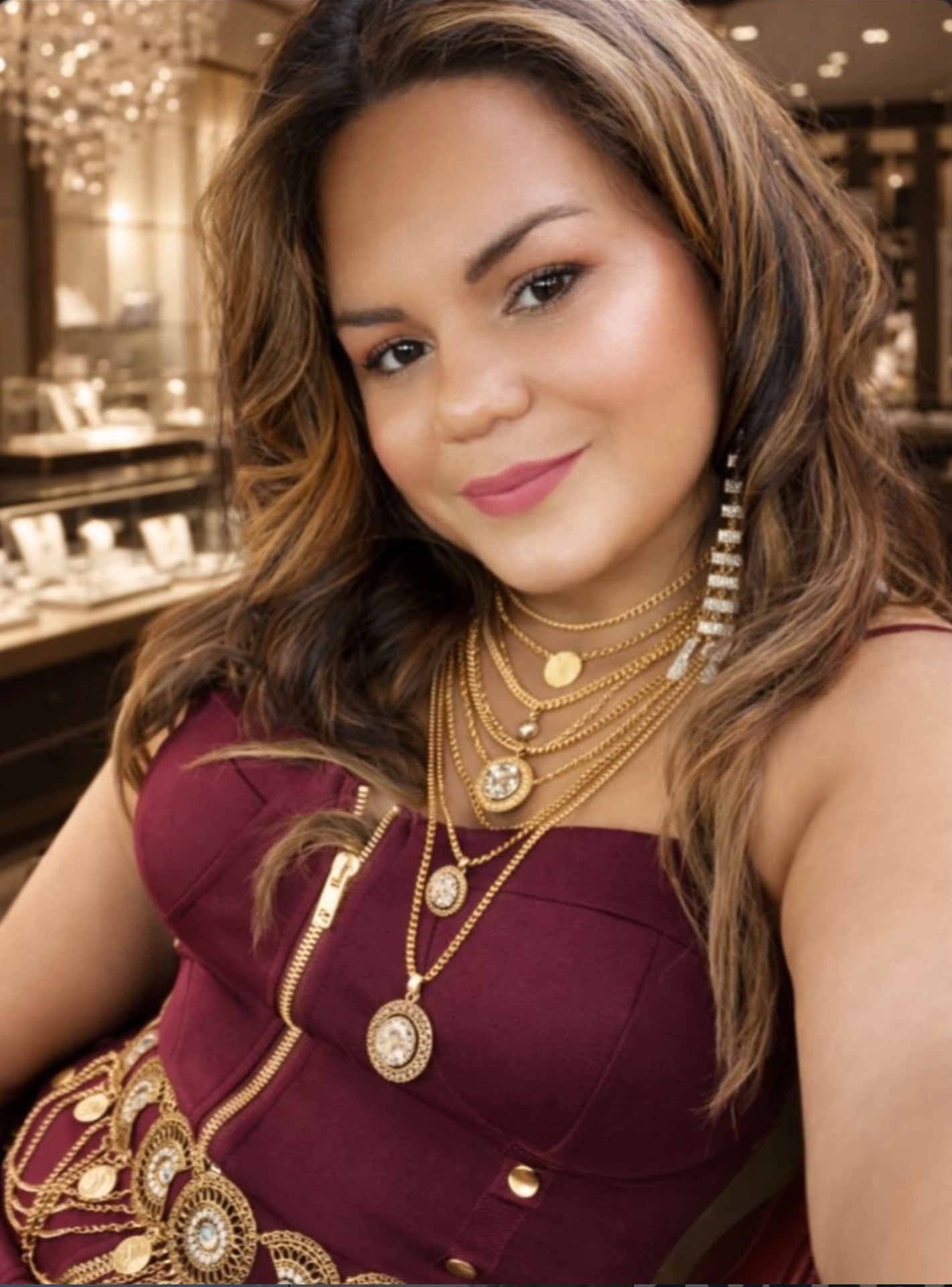 ZoJayshe founder wearing layered gold necklaces and jewelry